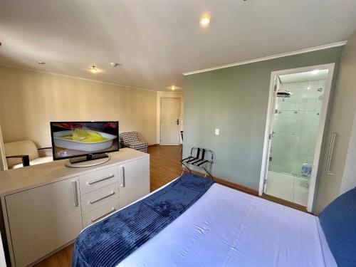 a bedroom with a bed and a bathroom with a shower at The Special Residence Flat - UH1908 in Sao Paulo