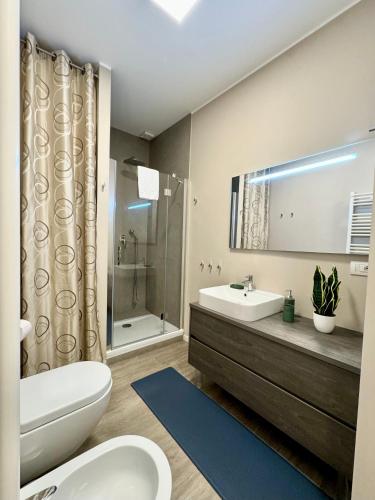 a bathroom with a toilet and a sink and a shower at Milano Duomo Design Apartment in Milan