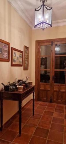 a dining room with a table and a chandelier at El Granero de Manzanares in Manzanares