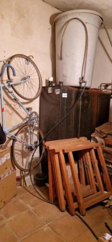 a bike parked next to a table and a bench at El Granero de Manzanares in Manzanares