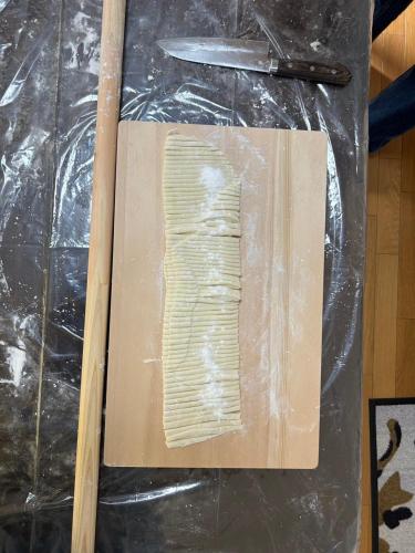 a cutting board with a piece of wood and a knife at 農家民宿河西園 in Takamatsu