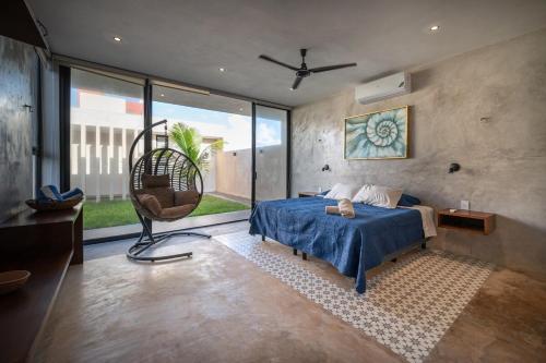 a bedroom with a blue bed and a chair at Casa en San Benito a steps away from the beach in San Benito