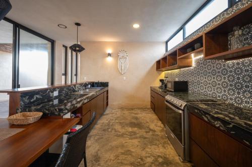 a kitchen with granite counter tops and a sink at Casa en San Benito a steps away from the beach in San Benito