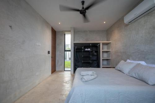 a bedroom with a bed with two towels on it at Casa en San Benito a steps away from the beach in San Benito