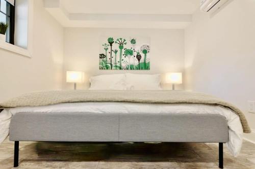 a bedroom with a large bed with two lamps at Lovely English Basement Apartment in Washington DC in Washington, D.C.