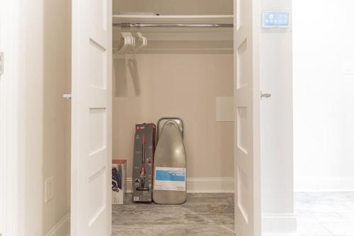 a closet with a snowboard in a room at Lovely English Basement Apartment in Washington DC in Washington, D.C.