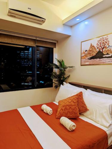 a bedroom with a bed with towels on it at 1 bedroom Cozy Escape in Manila