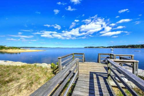 a wooden dock with a view of a body of water at Great location with Water Views in Harwich
