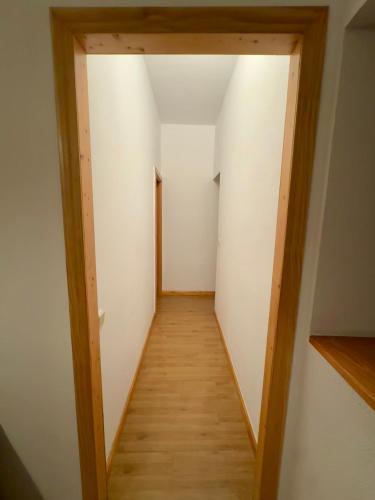a hallway of a room with white walls and wooden floors at Madrid Room Sol Center in Madrid