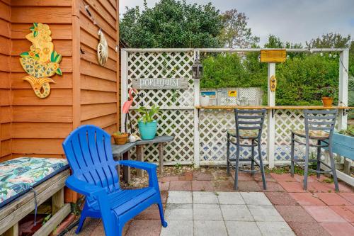 a patio with two blue chairs and a table at Pet-Friendly Wilmington Home with Fenced Yard! in Wilmington
