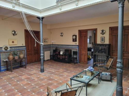 a living room with a fireplace and a table at El Granero de Manzanares in Manzanares
