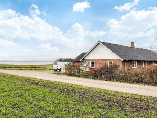 a house with a van parked next to a road at Scenic Pool House Retreat - By Traum Ferienwohnungen in Thyholm
