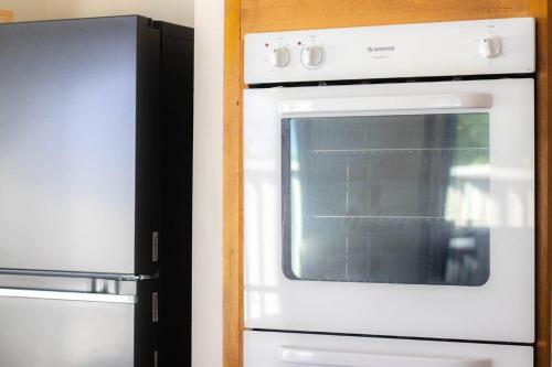 a white oven and a refrigerator in a kitchen at Sovereign Hill Getaway Walk to Attractions in Canadian