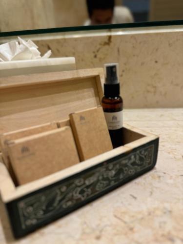 a bottle of whiskey in a box on a counter at Hotel Tres Vidas Acapulco in Barra Vieja