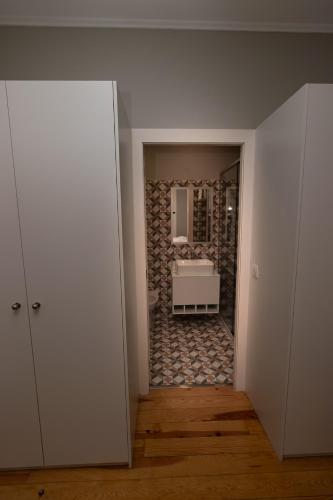 a bathroom with a tub and a sink in a room at ALM SANTA LUZIA in Guimarães