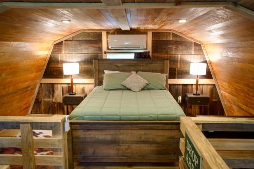 a bedroom with a bed in a wooden cabin at Wanee Lake Golf & RV Resort in Ashburn
