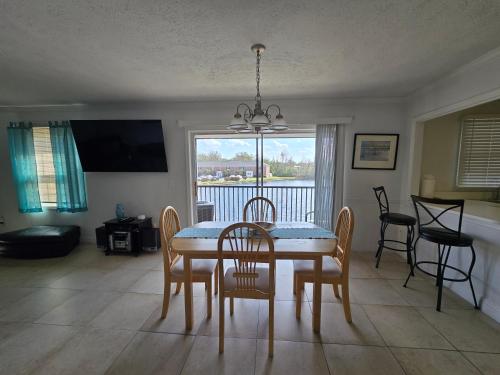 a dining room with a table and chairs with a view at Beautiful Condo Close to Busch Gardens in Tampa