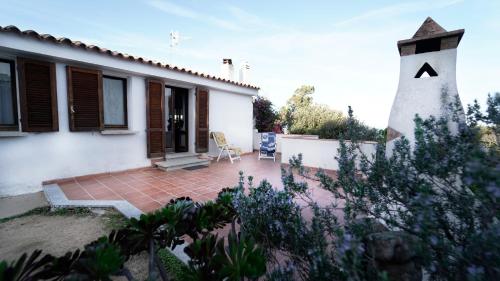 a house with a lighthouse in the yard at Villa panoramica tra natura e relax a due passi mare in Cannigione