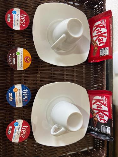 a group of white plates with cups on them at Chalé Makar in Serra do Cipo