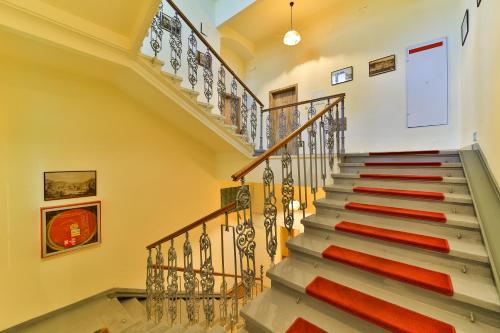 a staircase in a house with red cushions at Anzio apartments in Mariánské Lázně