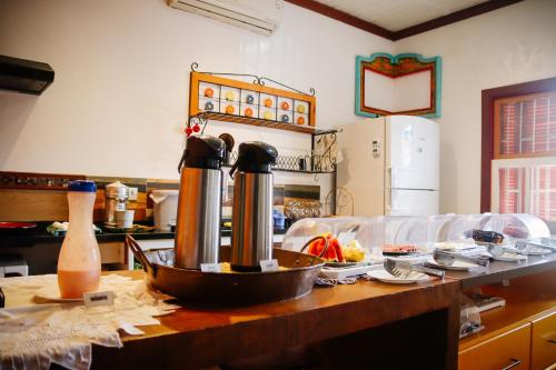 a kitchen with a table with a counter top with at Atlantic Pousada in São Sebastião