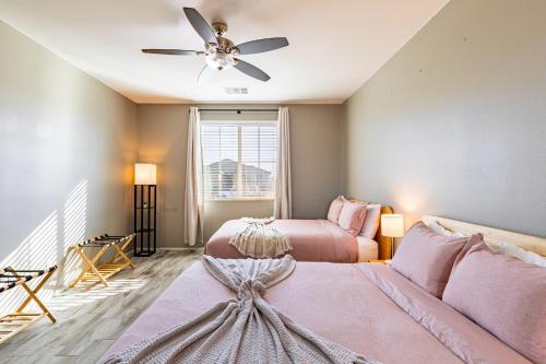 a bedroom with two beds and a ceiling fan at Luxe Indio Stay w Pool Tiki Bar Fire Pit Near Coachella Longfellow in Indio