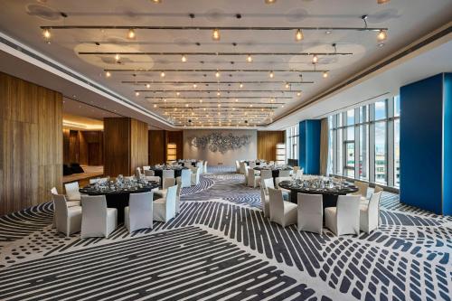 a conference room with tables and chairs and windows at W Taipei in Taipei