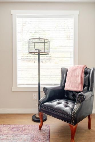 a black leather chair sitting next to a window at Hidden Gem in Seattle in Seattle