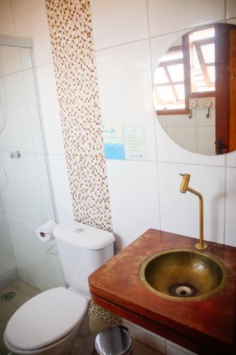 a bathroom with a sink and a toilet and a mirror at Atlantic Pousada in São Sebastião