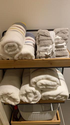 a bunch of towels are on a shelf at River view spacious apartment in London