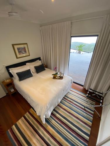 a bedroom with a bed and a large window at Balmoral 575 in Montville