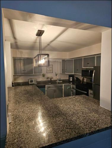 a kitchen with stainless steel appliances and a granite counter top at Deer Chalet in the heart of Pocono in Tobyhanna