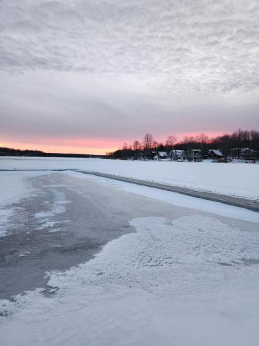 a view of a frozen lake with snow on it at Deer Chalet in the heart of Pocono in Tobyhanna