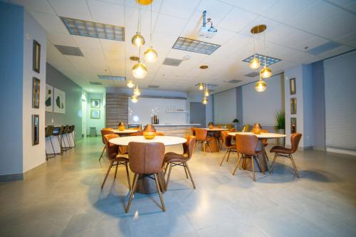 a restaurant with tables and chairs in a room at Warm and Comfy Studio in Miami