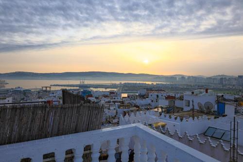 a view of a city at sunset from a building at Dar Tanjawiya in Tangier