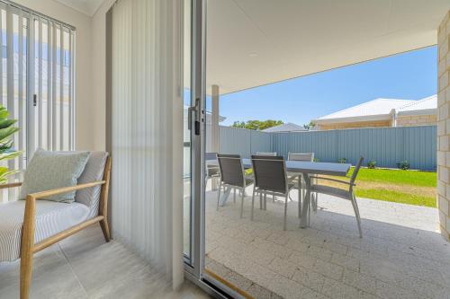 a dining room with a table and chairs on a patio at Bright & Airy 3-Bed House Near Rockingham Beach in Rockingham