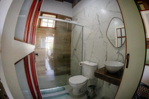 a bathroom with a toilet and a sink at Atlantic Pousada in São Sebastião