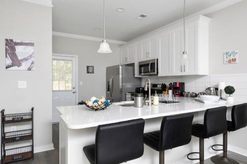 a kitchen with white cabinets and a white counter top at Cozy & Modern Home Close to Uptown & Airport in Charlotte
