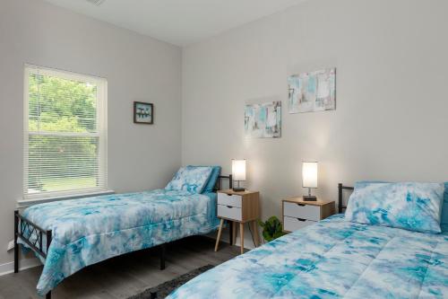 a bedroom with two beds and a window at Cozy & Modern Home Close to Uptown & Airport in Charlotte