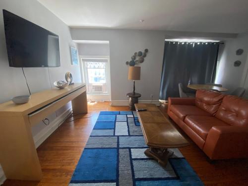 a living room with a couch and a flat screen tv at Cozy 1 bedroom apartment in Allentown