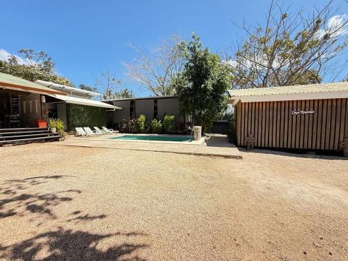 a house with a driveway next to a building at Nirvana Beach Home in Paraíso