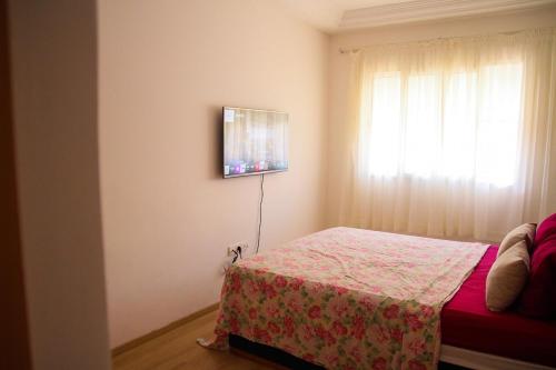 a bedroom with a bed and a window at quiet and modern apartment in Sale