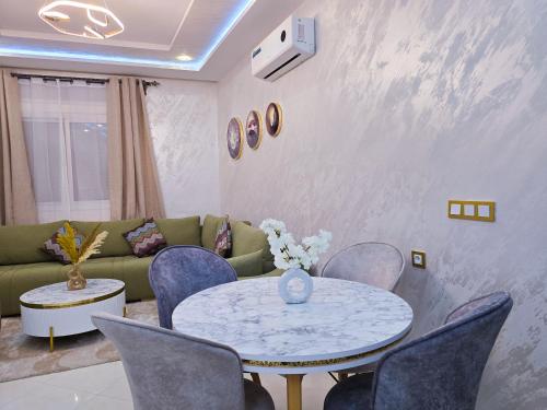 a living room with a couch and a table and chairs at Elite Holiday Home - Luxury & Centric Flat in Tangier