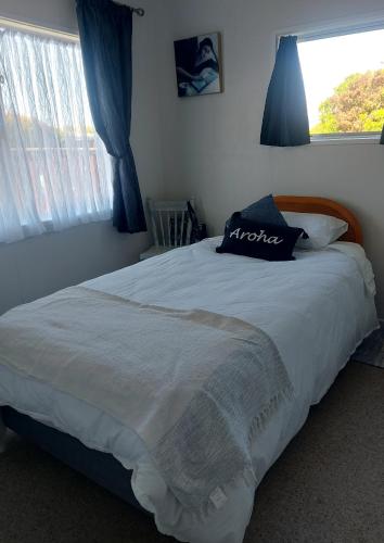 a large bed in a bedroom with a window at Three Doors Whole 3bdr Home Central Motueka in Motueka