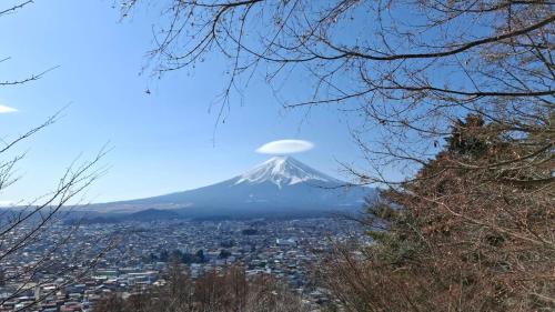 a mountain in the sky with a city at Bluebird Hotel in Fujikawaguchiko