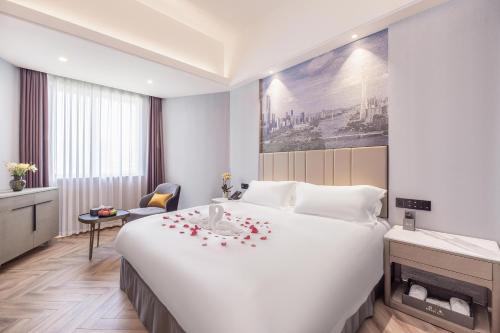 Ένα ή περισσότερα κρεβάτια σε δωμάτιο στο Guangzhou Tianhe Building