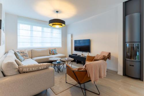 un salon avec un canapé et une télévision dans l'établissement Superb fully renovated semi-detached house for 6 people, à Le Touquet-Paris-Plage