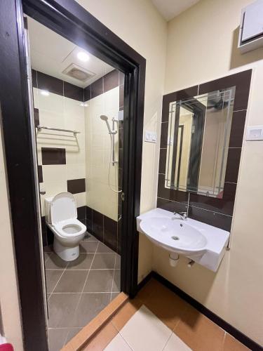 a bathroom with a sink and a toilet at Sera Sentosa Inn in Kampong Perin