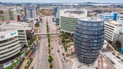 an aerial view of a city with tall buildings at Ecuabook Wyndham Garden Torre Sol 907 in Guayaquil