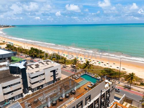 a view of a beach and the ocean at Arpoar Suítes by Day by Day in João Pessoa